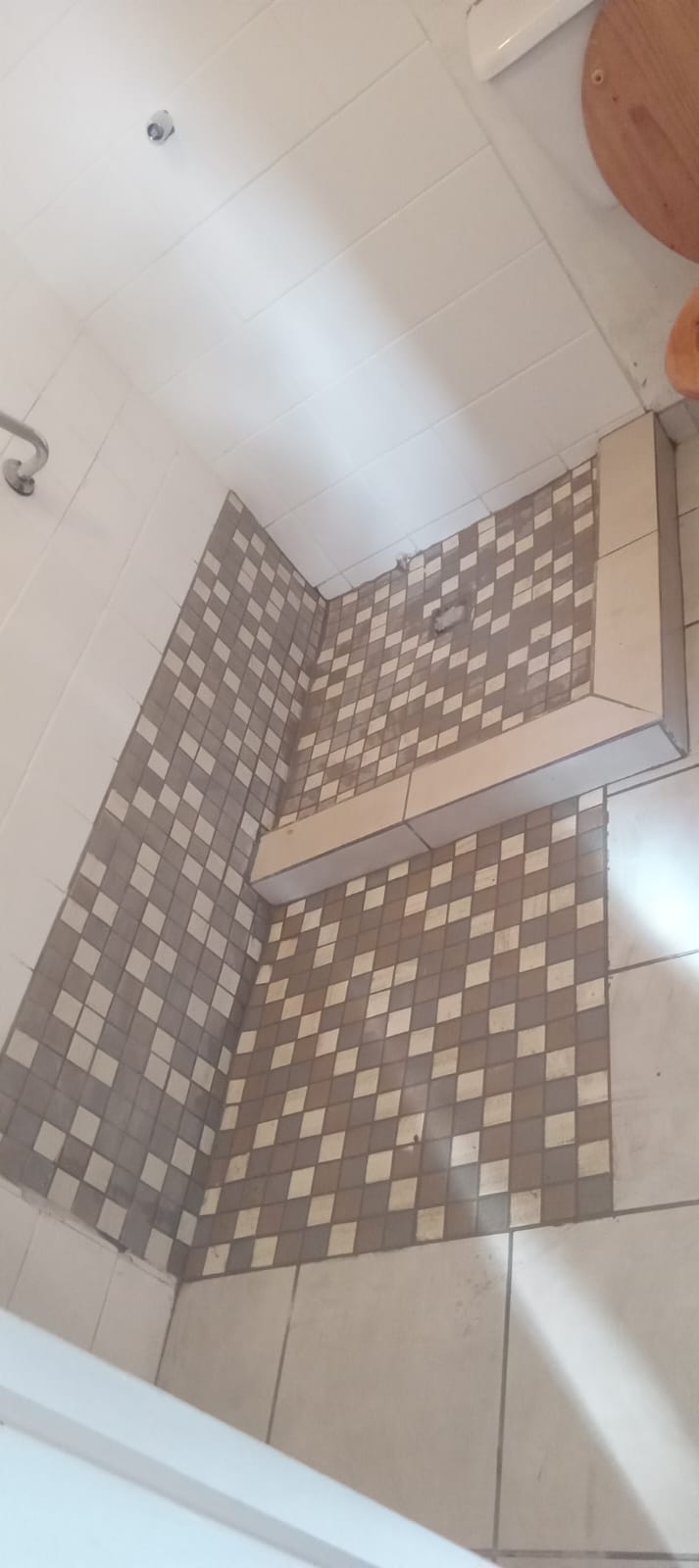 Tiled shower floor with mosaic feature