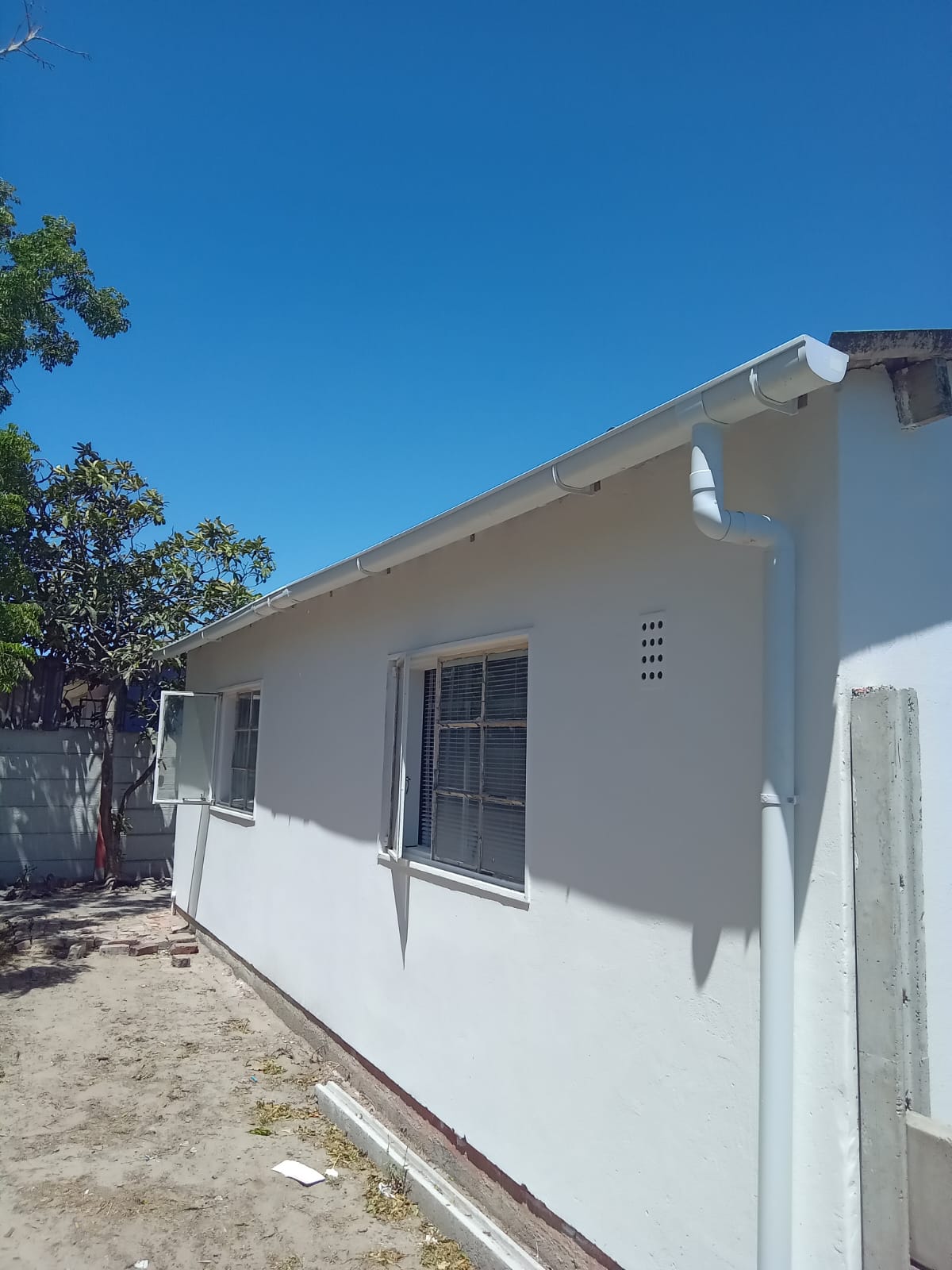 House exterior after — crisp white finish